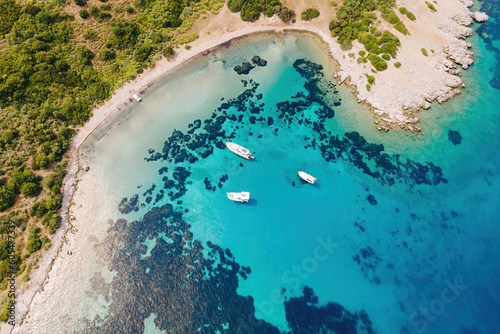 Fototapeta Naklejka Na Ścianę i Meble -  Aerial view of blue sea lagoon and yachts along the Aegean coast. Landscape of turkish riviera nature