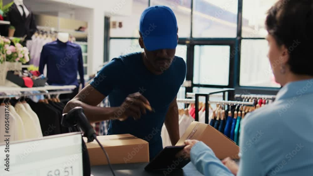 African american courier signing packaging report in modern boutique, discussing distribution details with worker. Woman manager working at online orders, preparing packages for delivery African american courier signing packaging report in modern boutique, discussing distribution details with worker. Woman manager working at online orders, preparing packages for delivery