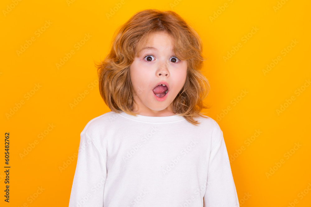 Excited kid boy on yellow isolated background. Surprised face, amazed emotions of child. Excited kid boy on yellow isolated background. Surprised face, amazed emotions of child.