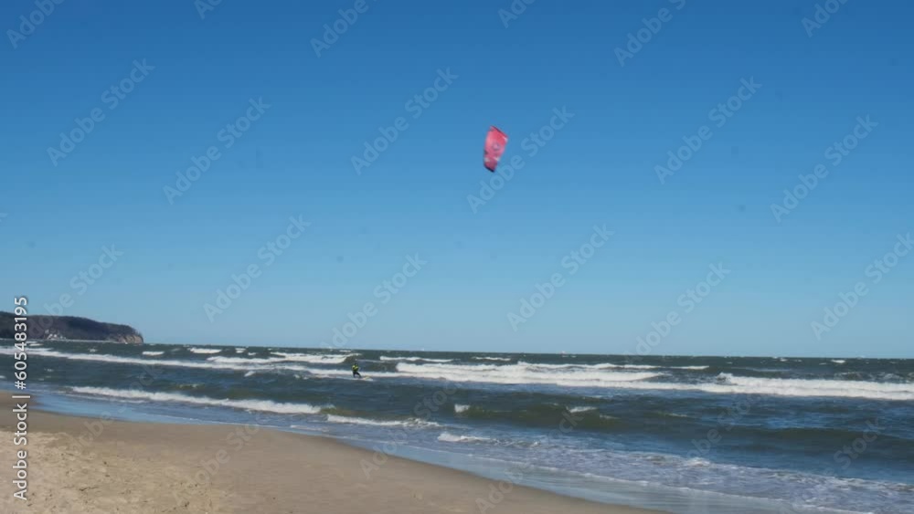 Wing Foiling kitesurfing wind surfing water outdoor sport in Baltic sea Dark blue clouds ocean water surface with foam waves before storm, dramatic seascape background. Wing Foiling kitesurfing wind surfing water outdoor sport in Baltic sea Dark blue clouds ocean water surface with foam waves before storm, dramatic seascape background.
