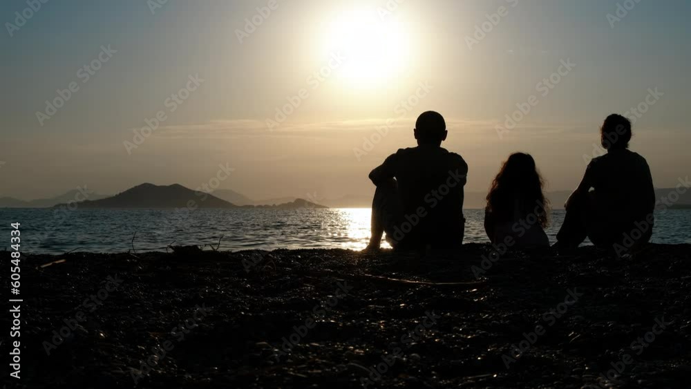Silhouette of a family on the beach at sunset. Silhouette of a family on the beach at sunset.