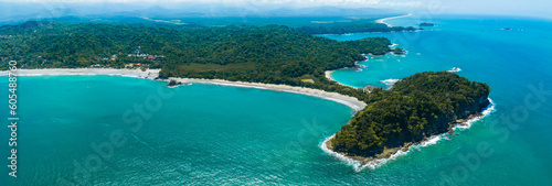 Aerial view of Manuel Antonio National Park in Costa Rica. The best Tourist Attraction and Nature Reserve with lots of Wildlife, Tropical Plants and paradisiacal Beaches on the Pacific Coast. photo