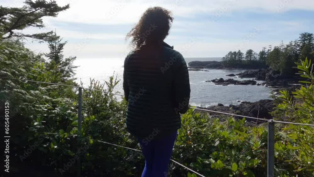 Adventure Woman on a rocky shore on the West Coast of Pacific Ocean. Spring Morning Sky. Ucluelet, Vancouver Island, British Columbia, Canada. Nature Background. Slow Motion Cinematic Adventure Woman on a rocky shore on the West Coast of Pacific Ocean. Spring Morning Sky. Ucluelet, Vancouver Island, British Columbia, Canada. Nature Background. Slow Motion Cinematic