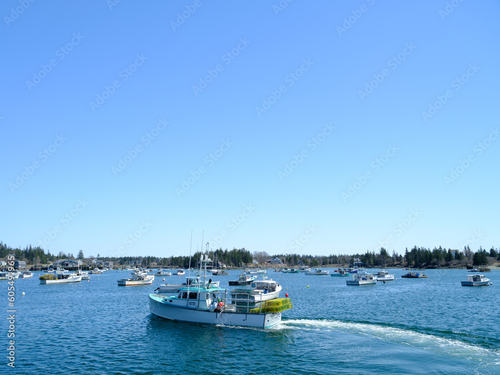 Lobster boat approaches the dock to unload it's lobster traps and pots on Vinalhaven Island Maine Lobster boat approaches the dock to unload it's lobster traps and pots on Vinalhaven Island Maine