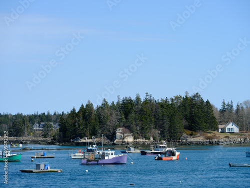 Fototapeta Naklejka Na Ścianę i Meble -  Lobster boats of all shapes and colors docked in the protected harbor on the colorful and quaint Vinalhaven Harbor Maine
