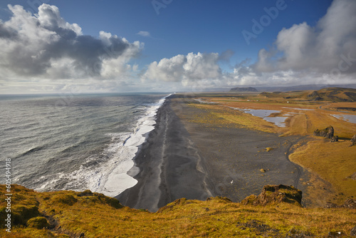 A view from Dyrholaey Island along a vast volcanic black sand beach, near the town of Vik, on the south coast of Iceland, Polar Regions photo