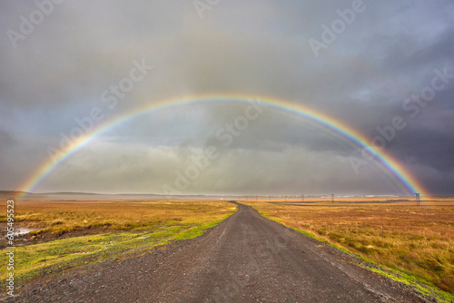 A rainbow straddles a road in countryside near Rif, Snaefellsnes peninsula, western Iceland, Polar Regions photo