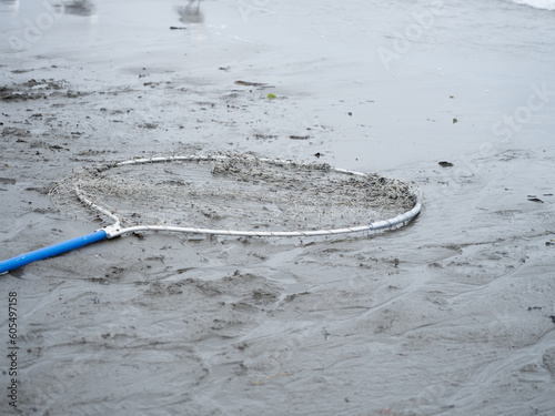 Dip net laying on the beach on the Kenai Peninsula of Alaska as the fisherman take a break from a run of fresh salmon photo