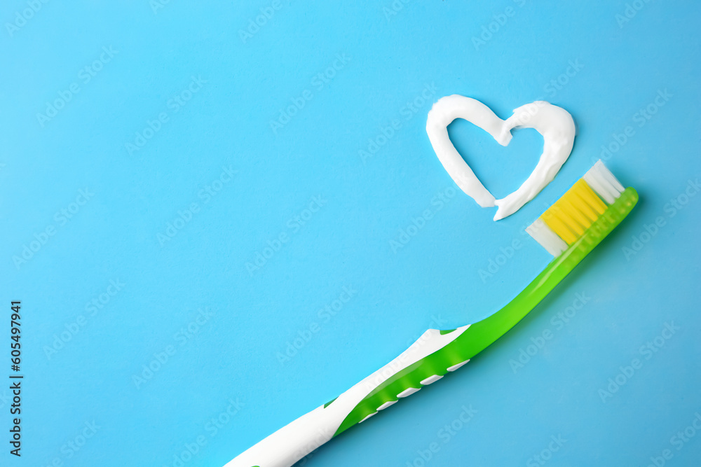 Heart made with toothpaste and brush on light blue background, top view. Space for text Heart made with toothpaste and brush on light blue background, top view. Space for text