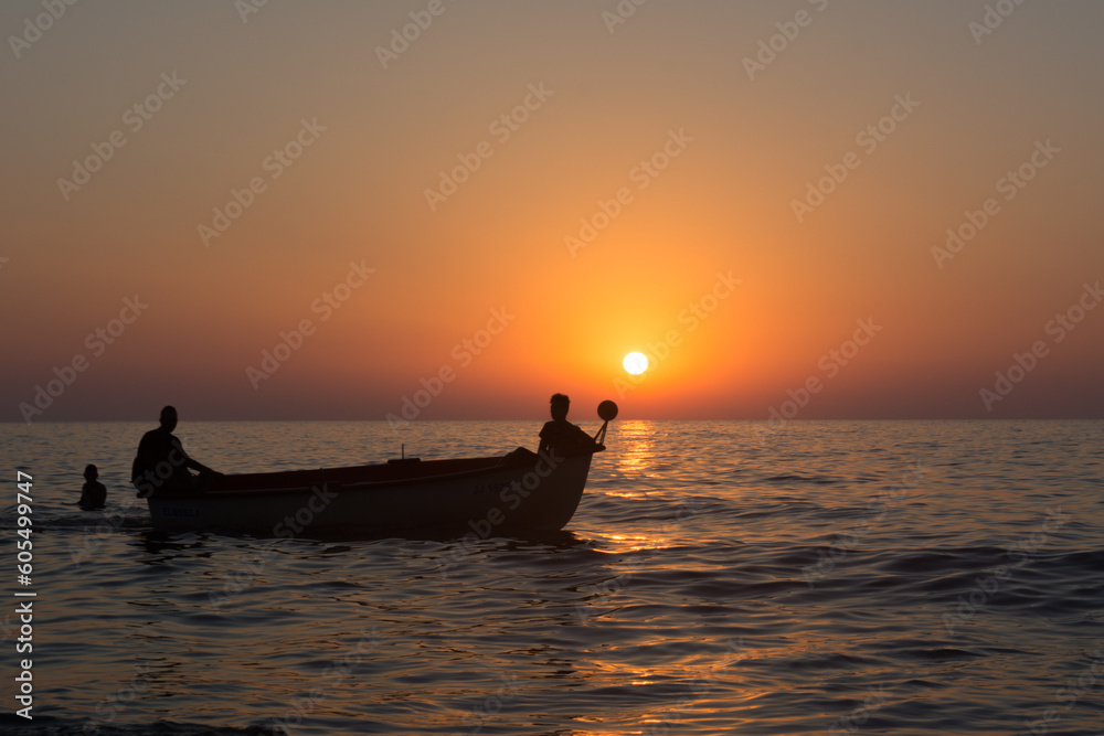 Fisherman in boat get fishing nets from river, Silhouette of fisherman,a dip net for fishing at Pakpra village, jijel Algeria Africa, Silhouette Lifestyle of African Fisherman Fishing Nets on boat