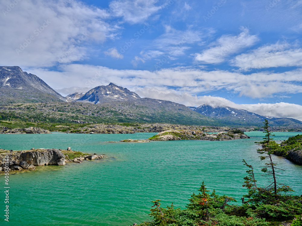 Beautiful Blue-green water of Bernard Lake on the Klondike Highway in Aiyansh British Columbia Canada and the rugged landscape surrounding the lake