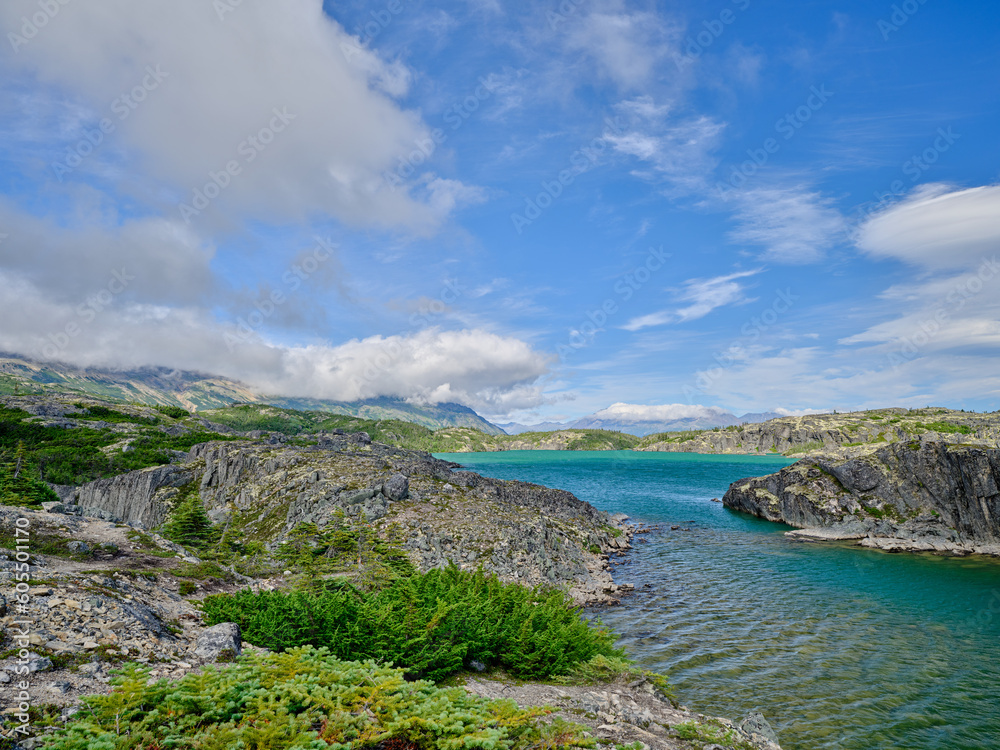 Beautiful Blue-green water of Bernard Lake on the Klondike Highway in Aiyansh British Columbia Canada and the rugged landscape surrounding the lake