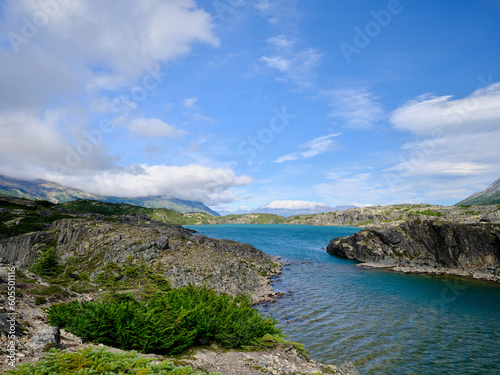 Beautiful Blue-green water of Bernard Lake on the Klondike Highway in Aiyansh British Columbia Canada and the rugged landscape surrounding the lake