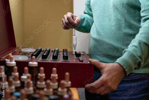 Adult man performing analysis with a radionic machine. Concept of alternative medicine.