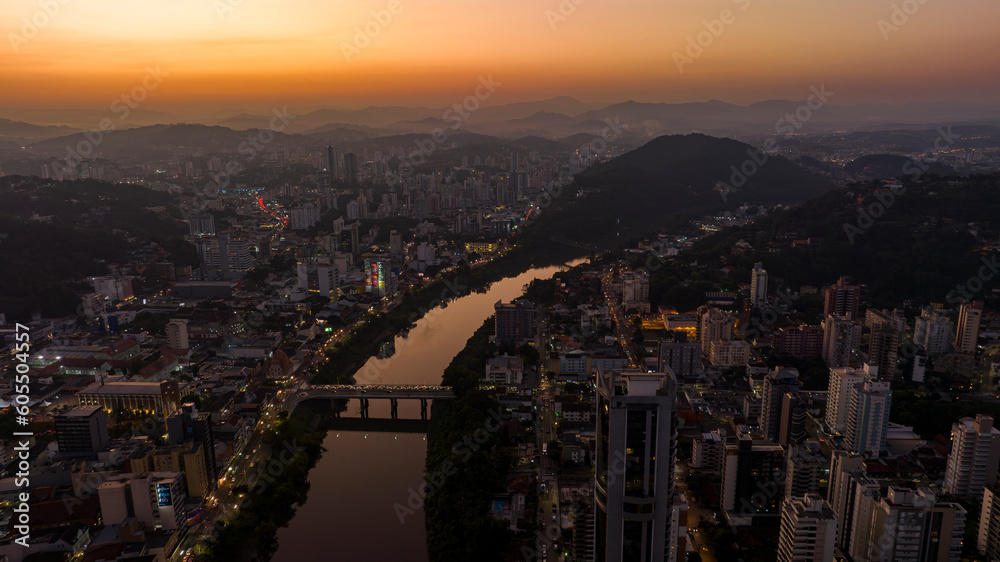 Fototapeta premium Aerial drone footage of the late afternoon with a beautiful sunset in Blumenau in Santa Catarina