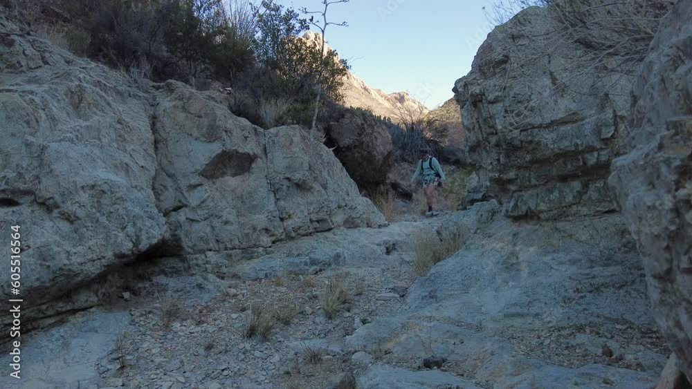 Woman Hikes Through Rock Walls of Wash in Big Bend Woman Hikes Through Rock Walls of Wash in Big Bend