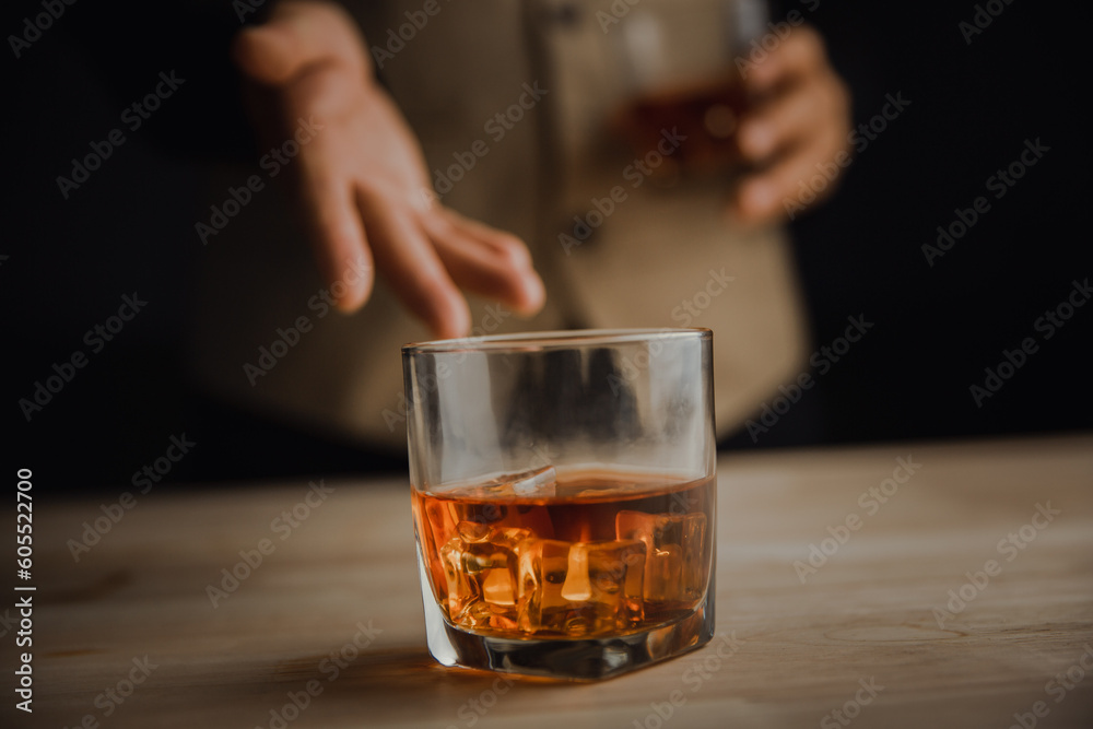 Bartender serving whiskey on wooden bar ,Close-up shot of whiskey glass Bartender serving whiskey on wooden bar ,Close-up shot of whiskey glass