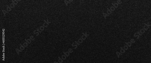Texture of a wood splinter pressed wall, black painted surface of dark pressed wood chipboard texture background, the texture of the wood particle board painted black color. 