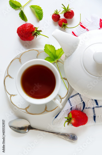 Delicious breakfast of tea, fresh bread rolls with sesame seeds and strawberries. isolated on white background. top view 