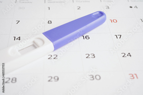 Pregnancy test for female on calendar, ovulation day.