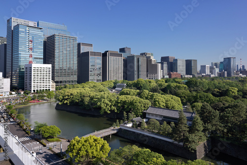 April 2023 Tokyo in the fresh greenery, beyond the Hirakawa Gate of the Imperial Palace, there are high-rise office buildings in Otemachi and Marunouchi.