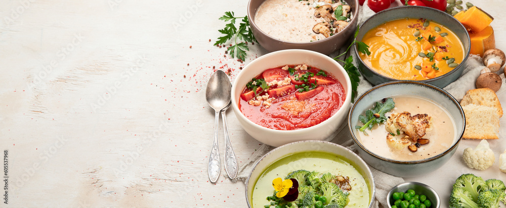 Composition with various soups, ingredients and space for text on white background. Healthy food.