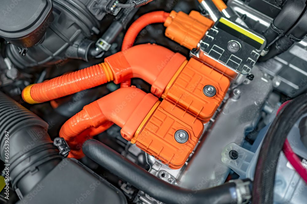 Powerful orange contacts of a hybrid automobile engine with elements of electric drive units Powerful orange contacts of a hybrid automobile engine with elements of electric drive units