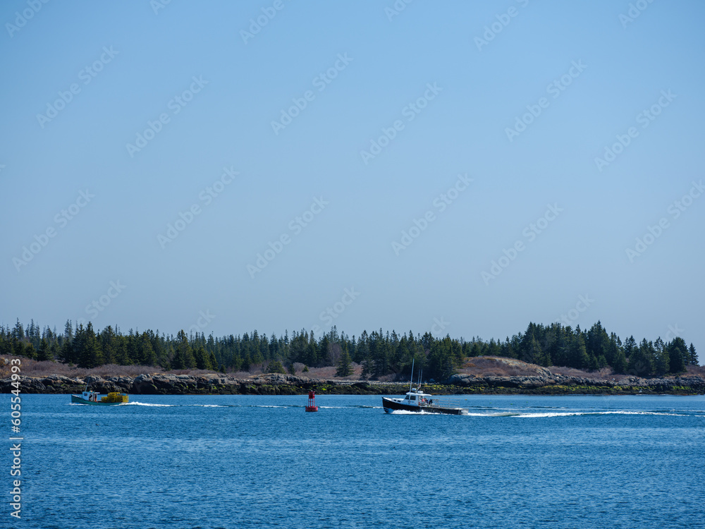 A loaded lobster boat heads into the harbor on Vinalhaven Island Maine