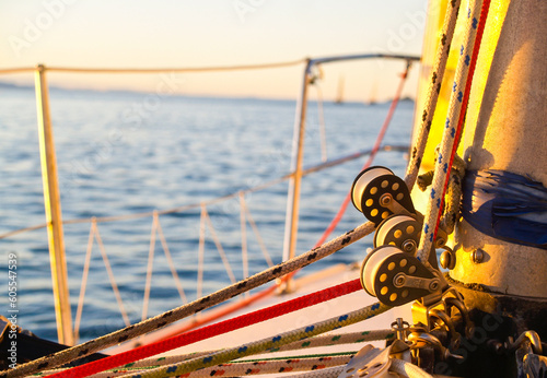 Nautical close-up rigging and pulleys at base of mast .