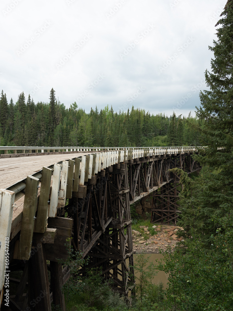 Vertical image of Old wooden plank bridge in British Columbia which was one of the bridges on the old section of the Alaska Highway