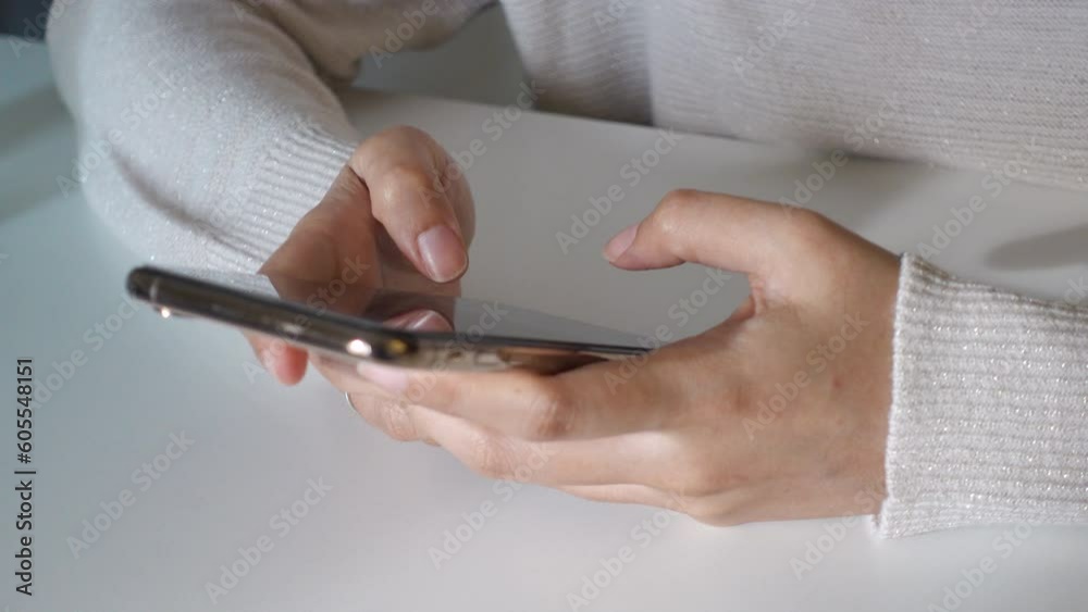 A hand's is using mobile phone, typing and chatting, social media, browsing and searching. Concept of social media, technology, smartphone at home. Application and connection. Scroll display A hand's is using mobile phone, typing and chatting, social media, browsing and searching. Concept of social media, technology, smartphone at home. Application and connection. Scroll display
