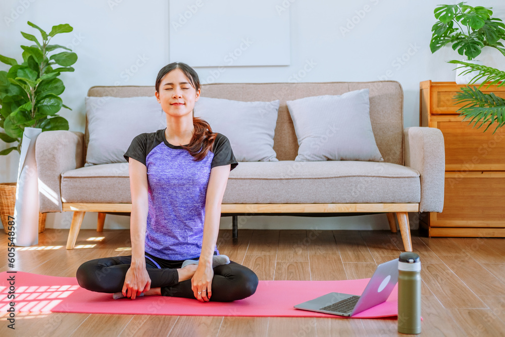 Young Asian healthy woman exercising with laptop at home Young Asian healthy woman exercising with laptop at home