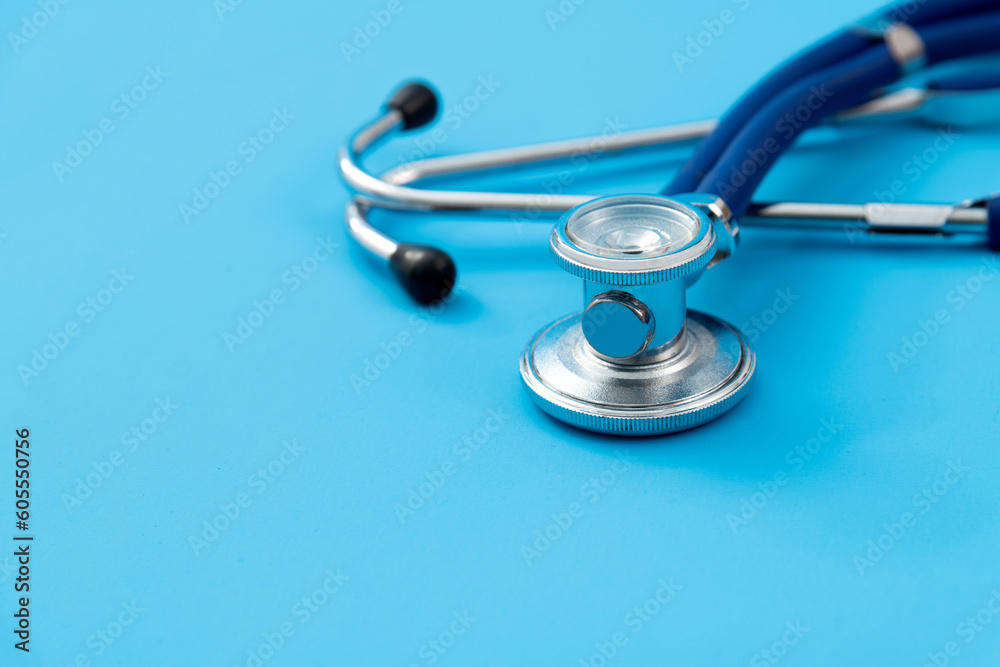 Close up of stethoscope on blue background Close up of stethoscope on blue background