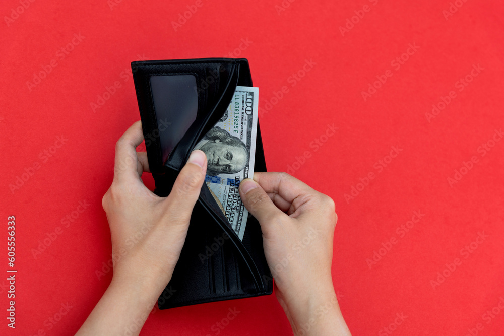 Woman hand holding a leather wallet with dollar Woman hand holding a leather wallet with dollar