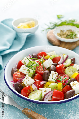 Greek salad. Vegetable salad with feta cheese, tomato, olives, cucumber, red onion and olive oil. Healthy vegetarian mediterranean diet food