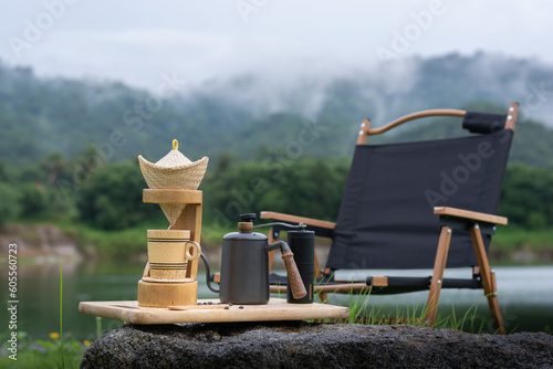 Classic coffee drip set with camping chair in rainy season nature.