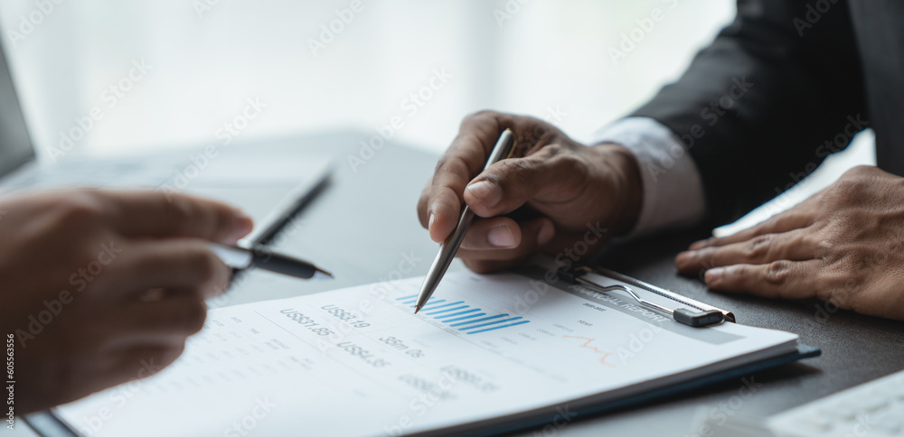 Two business men are analyzing and discussing data on graphs, charts, diagrams and on laptops in business finance to prepare to explain at a meeting. Two business men are analyzing and discussing data on graphs, charts, diagrams and on laptops in business finance to prepare to explain at a meeting.