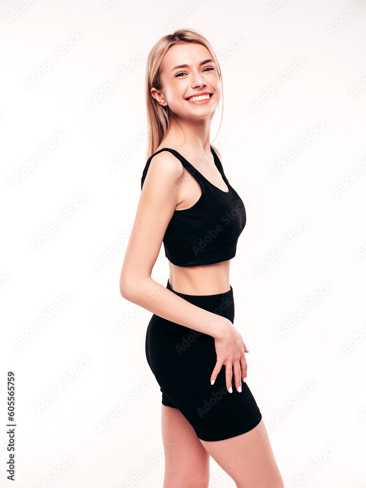 Young beautiful smiling blond female in summer black cycling shorts costume clothes. Sexy carefree woman posing on white in studio. Positive model having fun. Cheerful and happy Young beautiful smiling blond female in summer black cycling shorts costume clothes. Sexy carefree woman posing on white in studio. Positive model having fun. Cheerful and happy