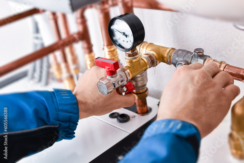 Plumbing concept or service worker. Copper pipelines close up with analog watch pressure water.