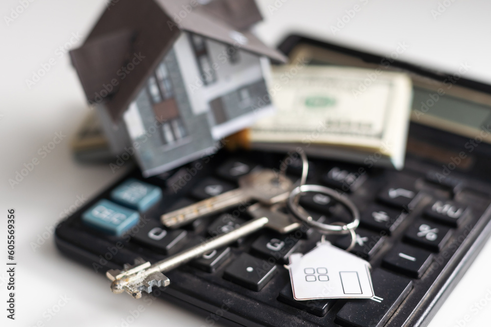 house sitting with a calculator and dollar