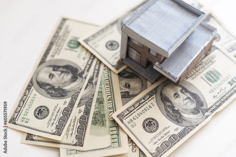 paper house model on background of US dollars banknotes. Housing market, purchase or rental of real estate paper house model on background of US dollars banknotes. Housing market, purchase or rental of real estate