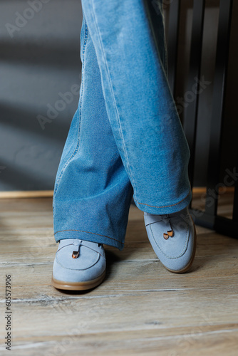 Slender female legs in jeans and blue loafers. Collection of summer women's shoes. Stylish women's shoes for summer © Дмитрий Ткачук