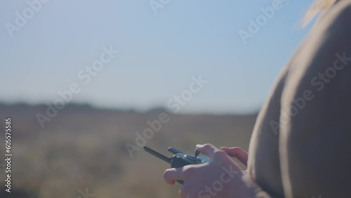 girl using remote to fly drone