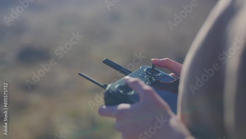 close up girl flying a drone in a field