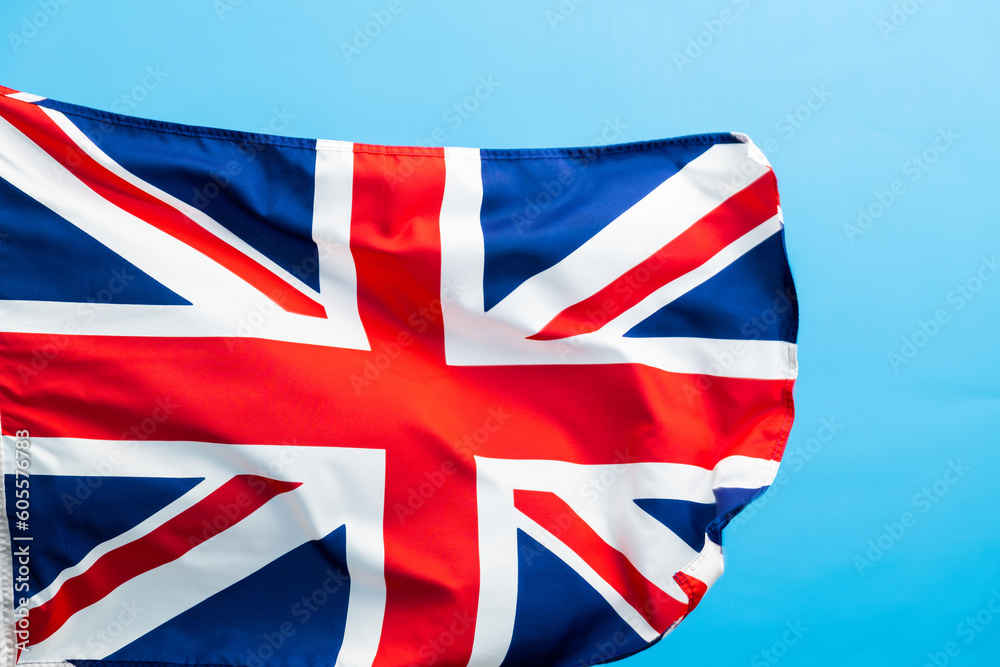 Fototapeta premium British flag waving on blue background