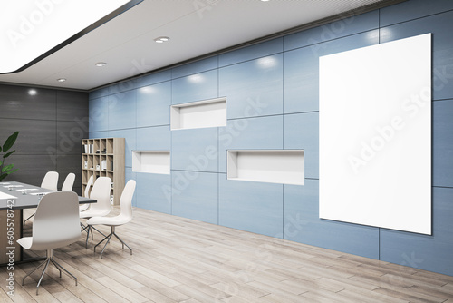 Fotografia Perspective view on blank white poster with space for advertising logo or text on light blue wall background in spacious conference room with black meeting table on wooden floor