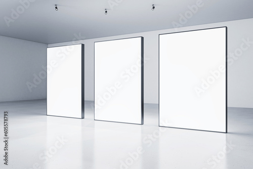 Three blank white glowing banners in grey hall interior with concrete floor and light walls. Presentation concept. Mockup, closeup, 3D Rendering