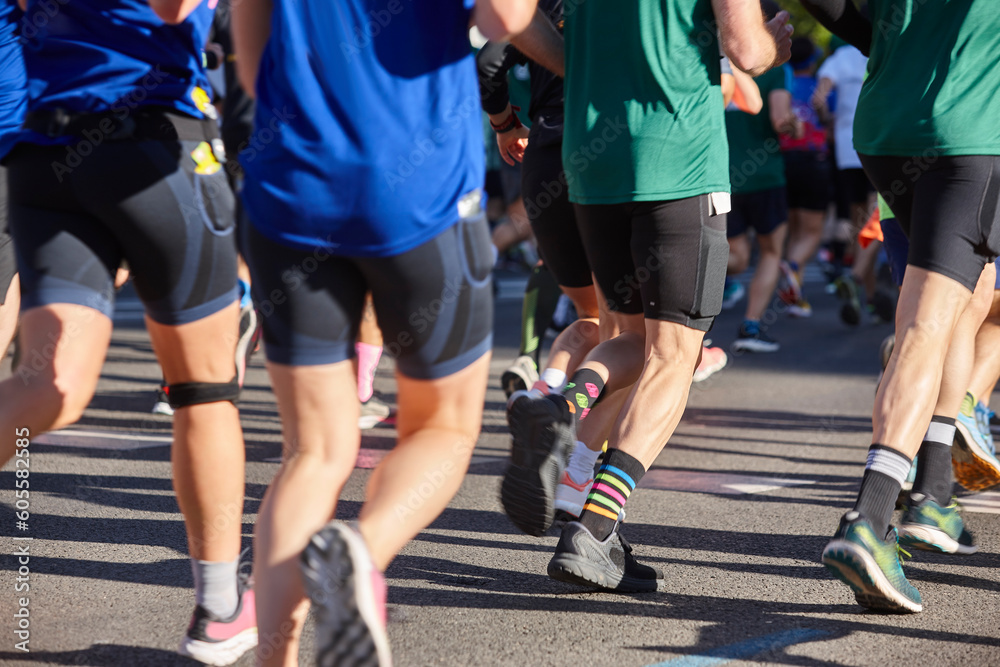 Runners on the street. Healthy lifestyle. Jogging exercise. Athletics Runners on the street. Healthy lifestyle. Jogging exercise. Athletics