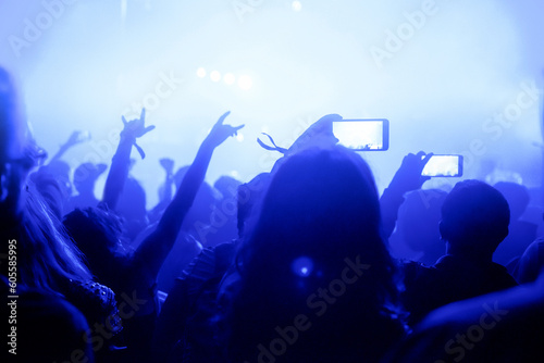 Crowd of people recording a concert with smart phones