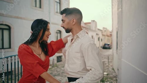 Hot hispanic dancers performing seductive choreography on city street close up.